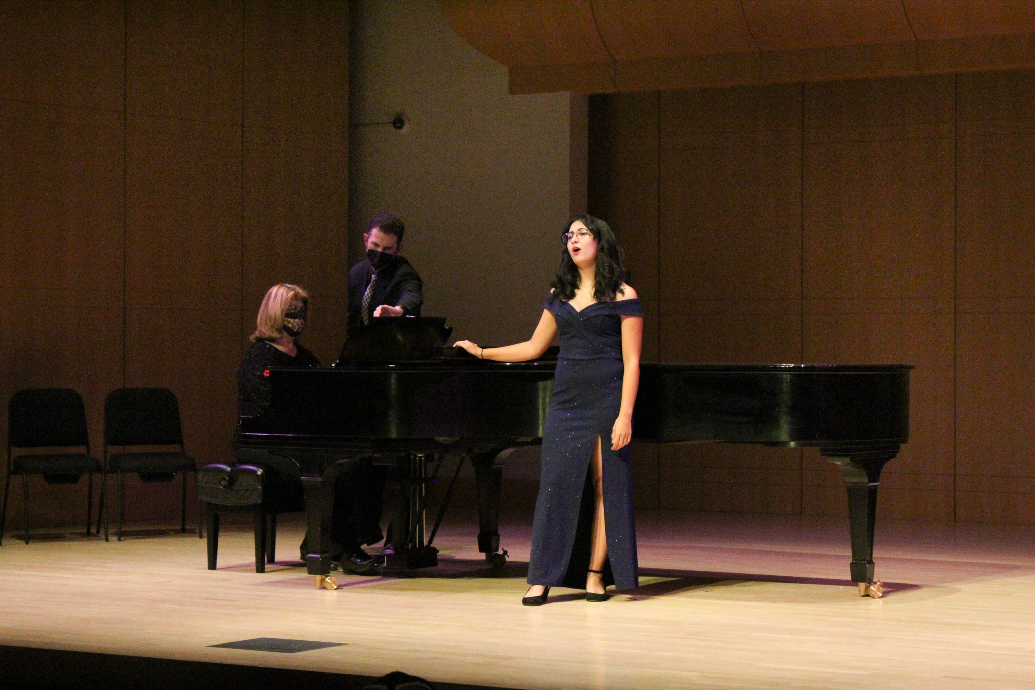 Vocal student singing with piano accompaniment on Schroeder Stage
