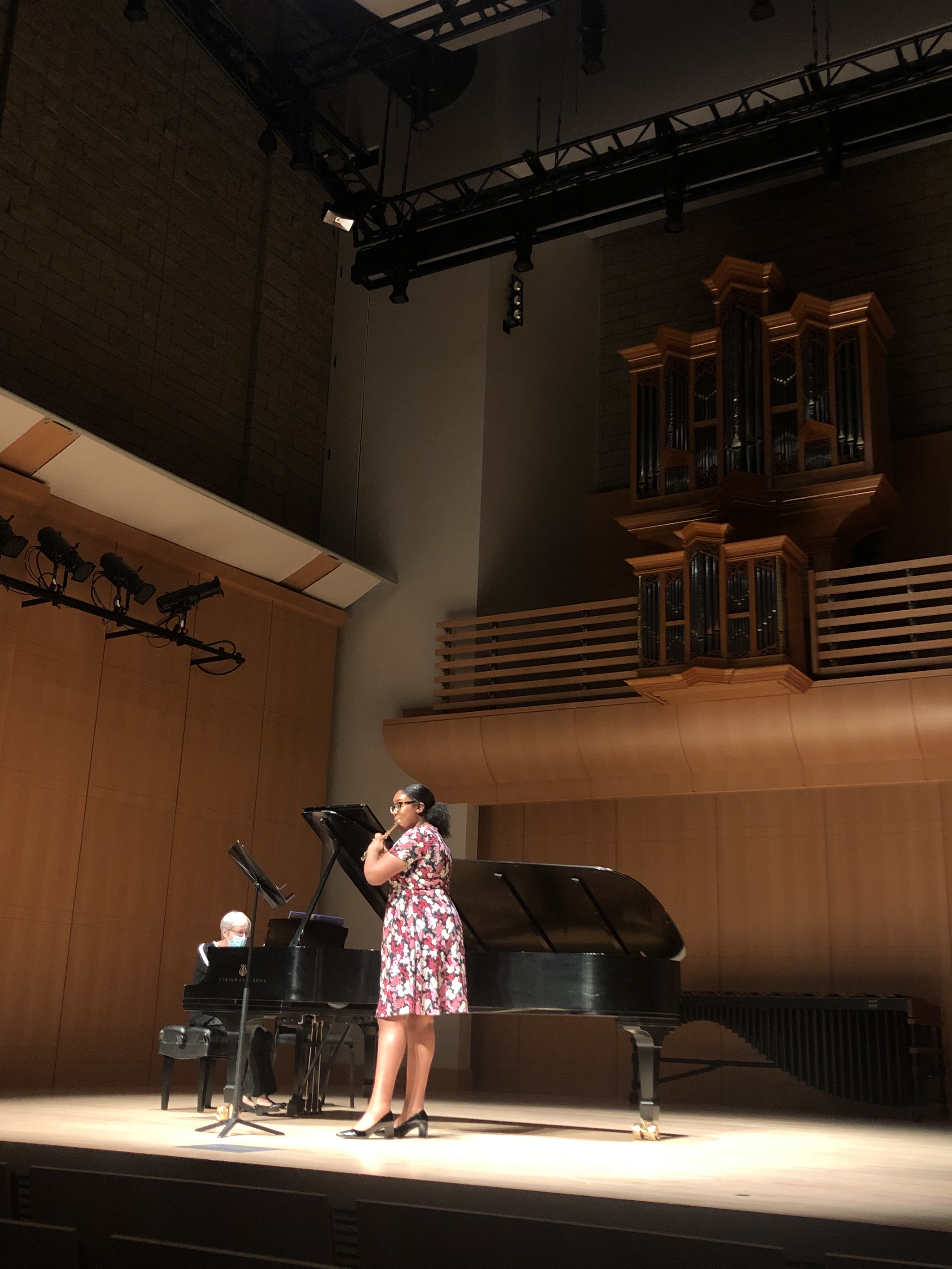 Student playing flute on stage