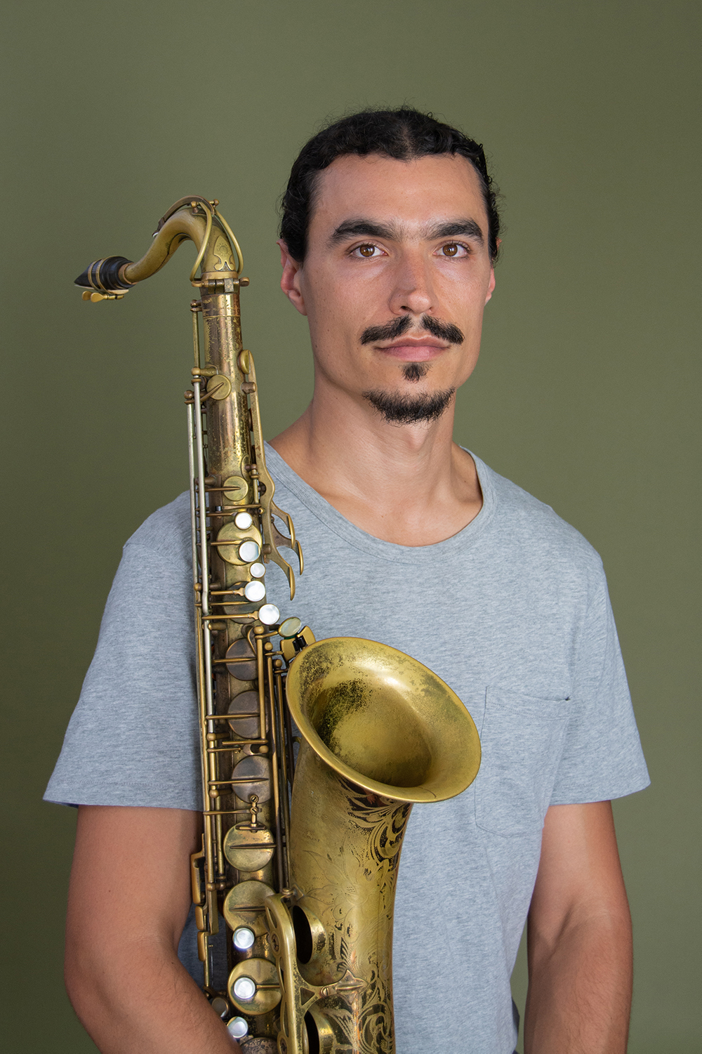 Raffi Garabedian Headshot holding saxophone